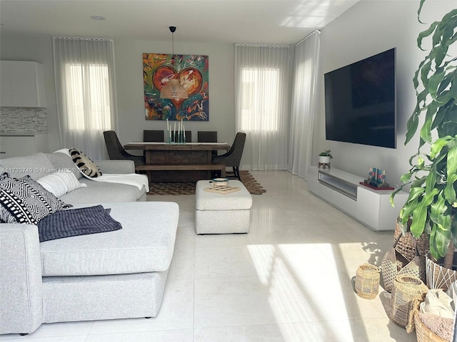 living area with a healthy amount of sunlight and light tile patterned flooring