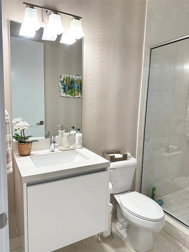 full bathroom featuring toilet, a stall shower, tile patterned flooring, and vanity