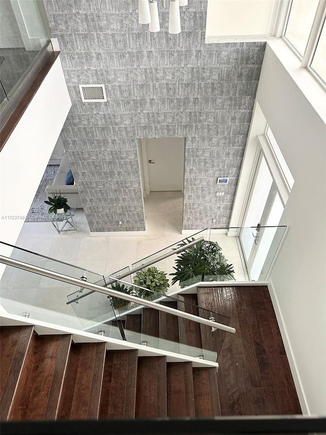 stairway with baseboards and visible vents