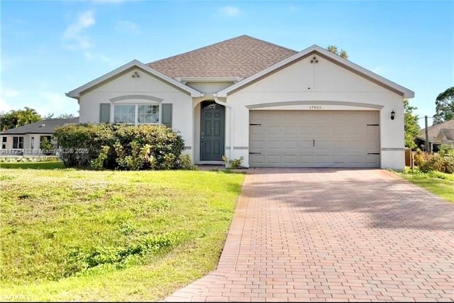 single story home featuring a garage and a front yard