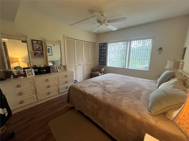 bedroom with ceiling fan, dark hardwood / wood-style flooring, and a closet