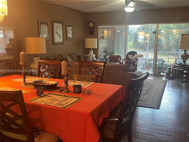 dining room with ceiling fan and dark wood-type flooring