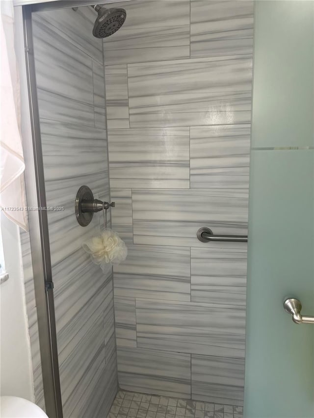 bathroom with tiled shower