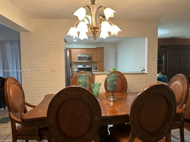 tiled dining space featuring an inviting chandelier