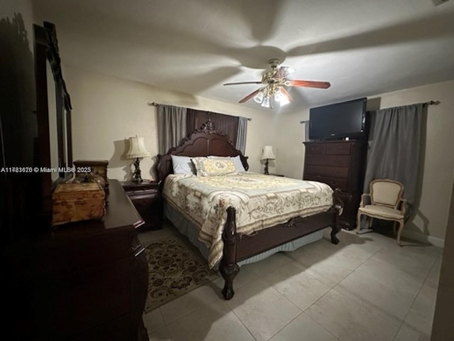 bedroom with ceiling fan and light tile patterned floors