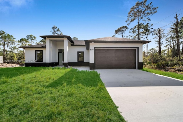 view of front of property with a front yard and a garage