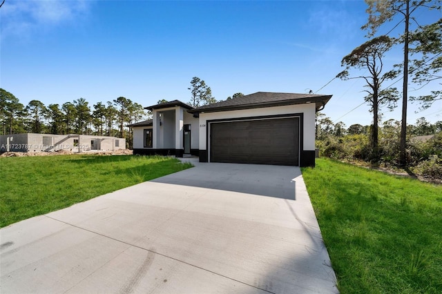 view of front of property featuring a front lawn and a garage