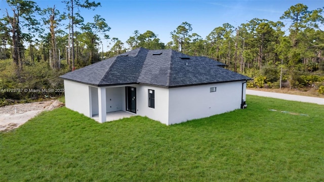 back of house with a patio area and a yard