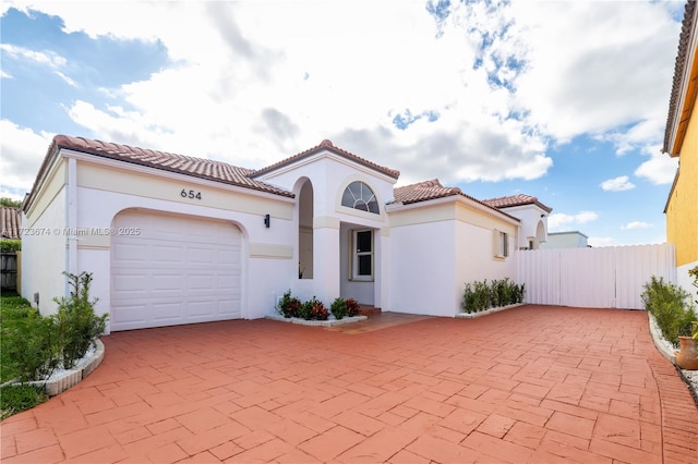 mediterranean / spanish house featuring a garage