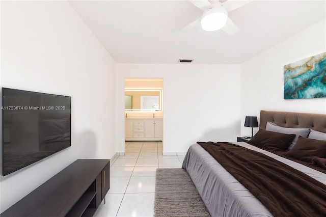 tiled bedroom with ensuite bath and ceiling fan