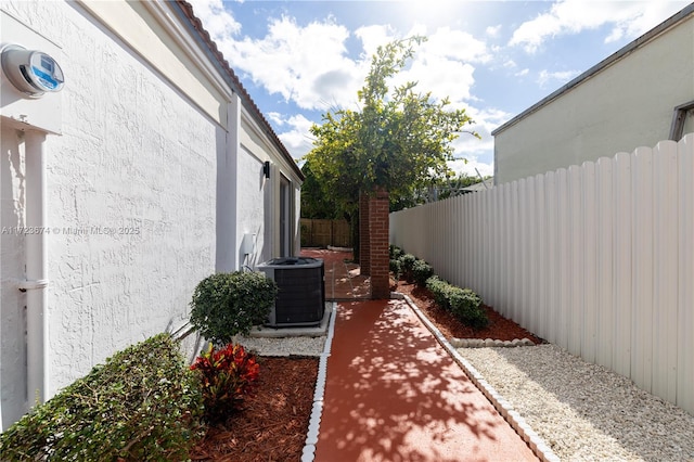 exterior space featuring central air condition unit and a patio area