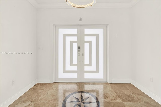 foyer with ornamental molding and french doors