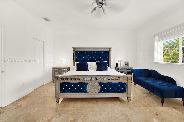 bedroom with ceiling fan and crown molding