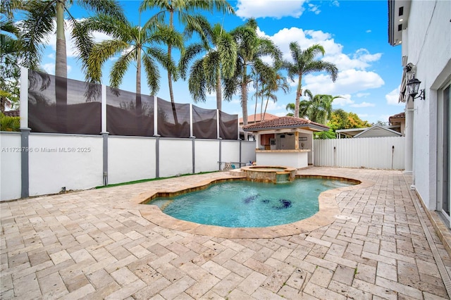 view of pool with an in ground hot tub and a patio