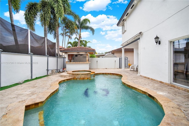 view of pool with an in ground hot tub and a patio