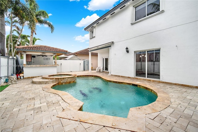 view of pool with ceiling fan, an in ground hot tub, and a patio