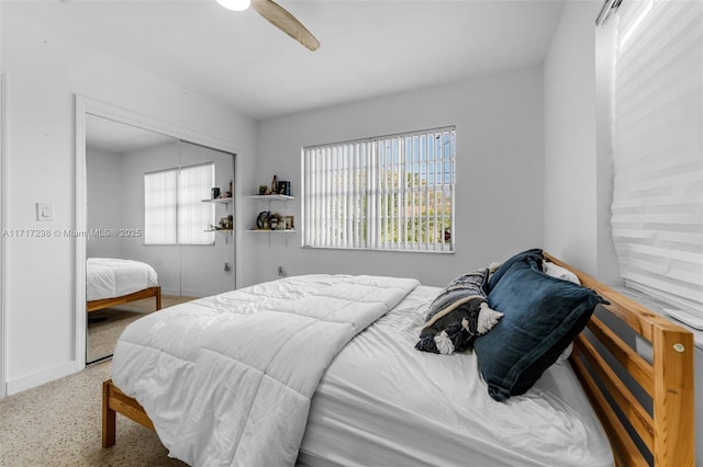 bedroom with ceiling fan and a closet