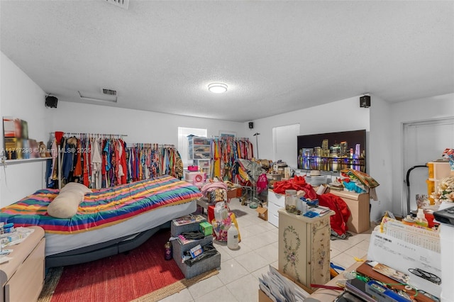 miscellaneous room with a textured ceiling and light tile patterned flooring