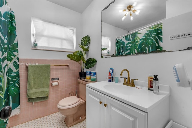 bathroom featuring vanity, tile walls, tile patterned floors, and toilet