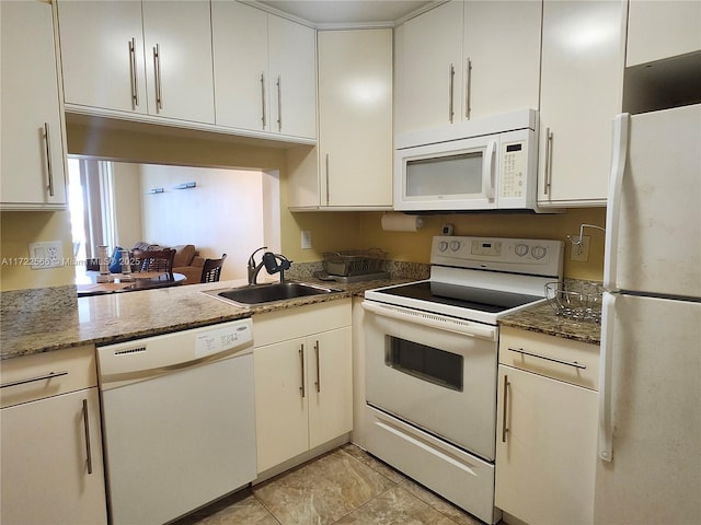 kitchen featuring light tile patterned flooring, dark stone countertops, white appliances, and sink