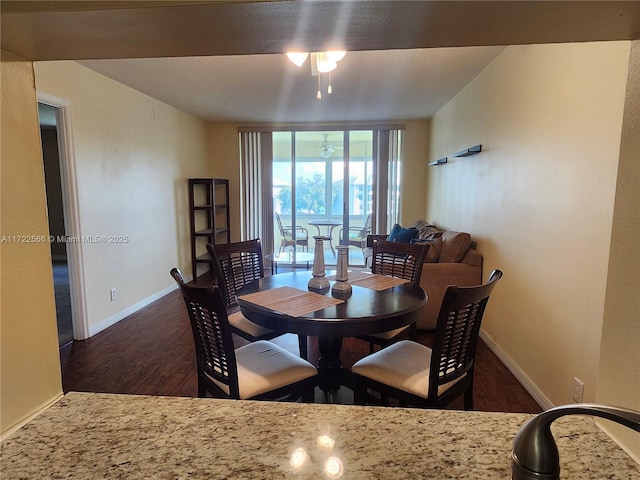 dining room featuring ceiling fan and dark wood-type flooring