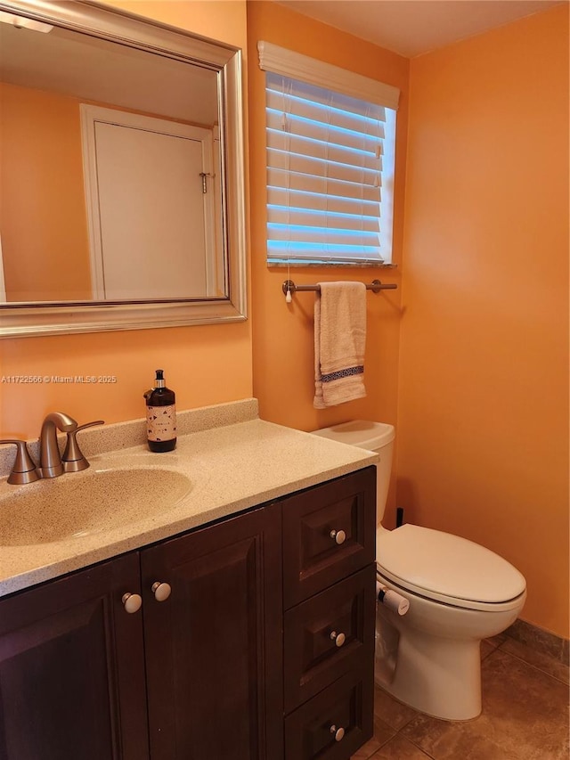 bathroom featuring tile patterned floors, vanity, and toilet