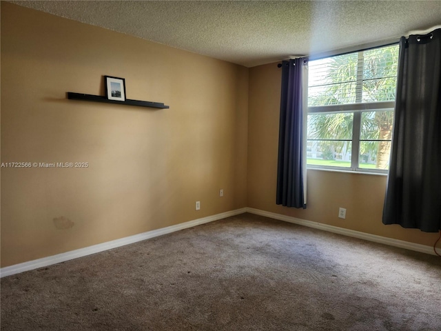 carpeted spare room featuring a textured ceiling and a healthy amount of sunlight