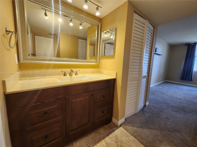 bathroom with a textured ceiling and vanity