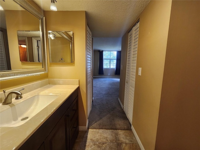 bathroom featuring a textured ceiling and vanity