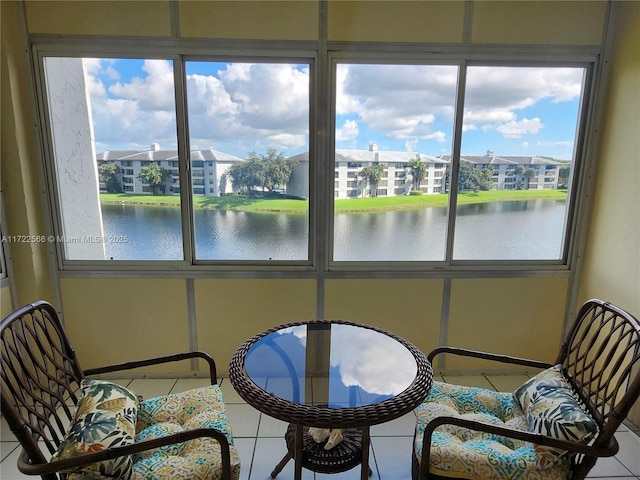 sunroom featuring a water view