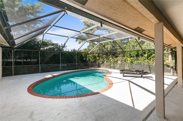 view of pool with a patio and a lanai