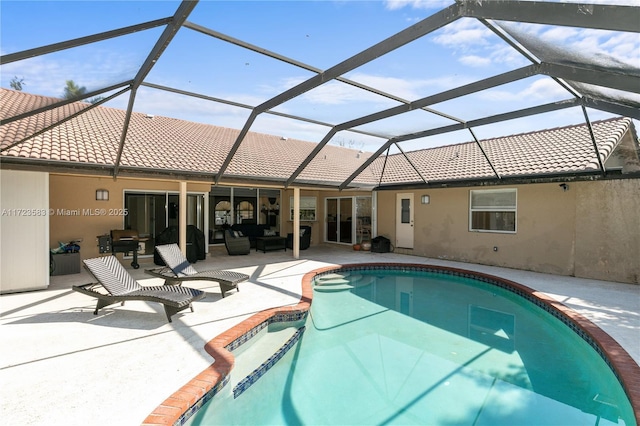 view of swimming pool with outdoor lounge area, a patio, a lanai, and a grill