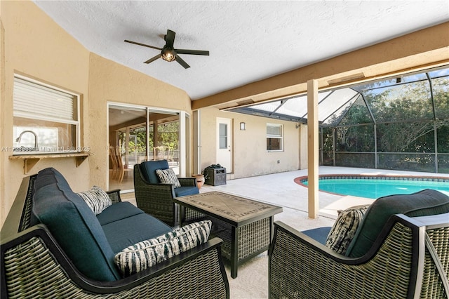 exterior space featuring ceiling fan, a patio area, a lanai, and an outdoor hangout area