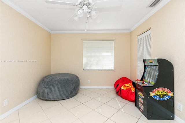 sitting room featuring ceiling fan, light tile patterned flooring, and crown molding