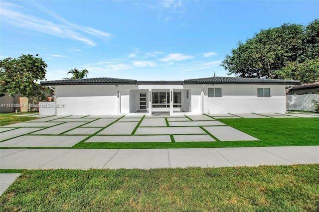 view of front facade featuring a front yard and a patio