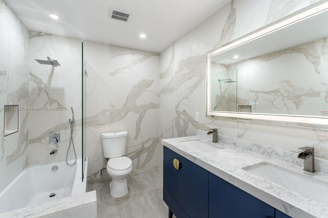 full bathroom with tiled shower / bath, vanity, and toilet