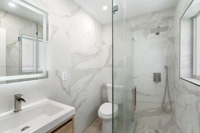 bathroom with vanity, an enclosed shower, tile walls, and toilet