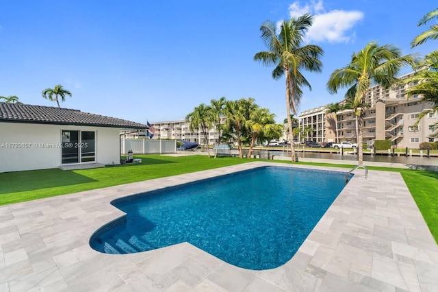 view of swimming pool with a patio and a lawn