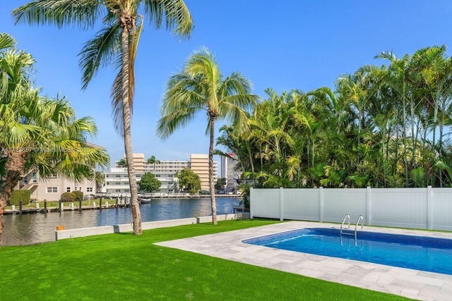 view of pool featuring a water view and a lawn