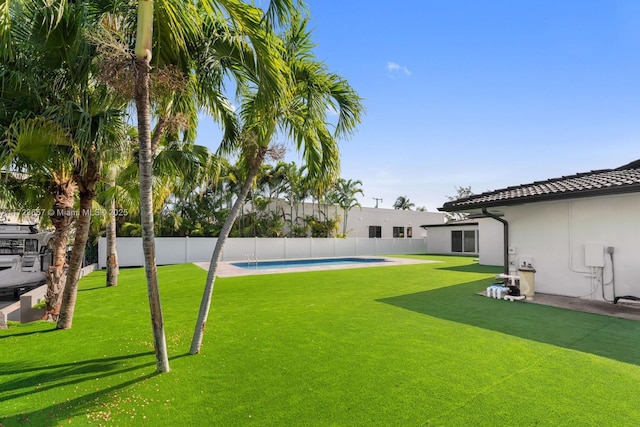 view of yard with a fenced in pool