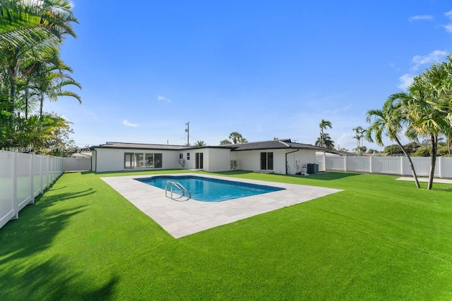 view of pool with a yard, a patio area, and central air condition unit