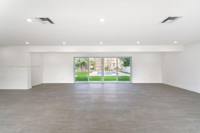 unfurnished room with concrete flooring