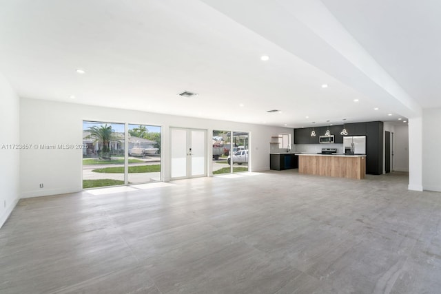 unfurnished living room with french doors