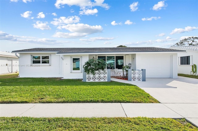 ranch-style house featuring a garage and a front lawn