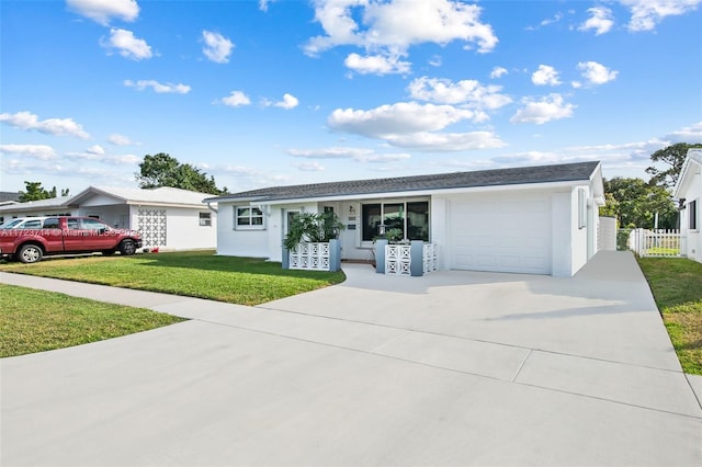 single story home with a garage and a front lawn