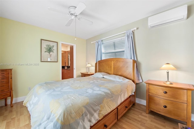 bedroom with a wall mounted air conditioner, ceiling fan, and light hardwood / wood-style flooring