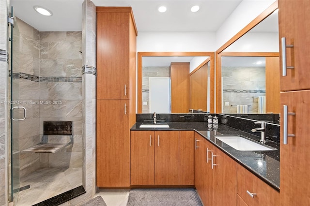 bathroom with tile patterned floors, vanity, and an enclosed shower