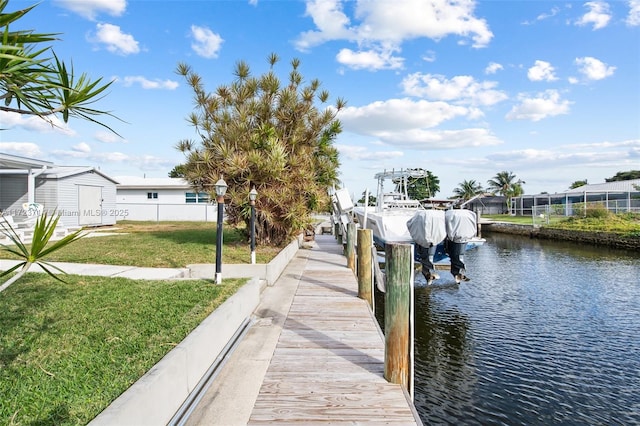 dock area featuring a yard and a water view