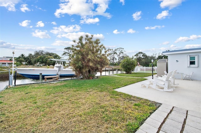 view of yard featuring a boat dock, a patio, and a water view