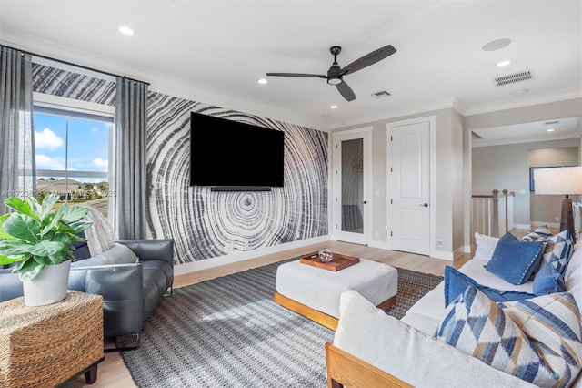 living room featuring ceiling fan, crown molding, and wood-type flooring